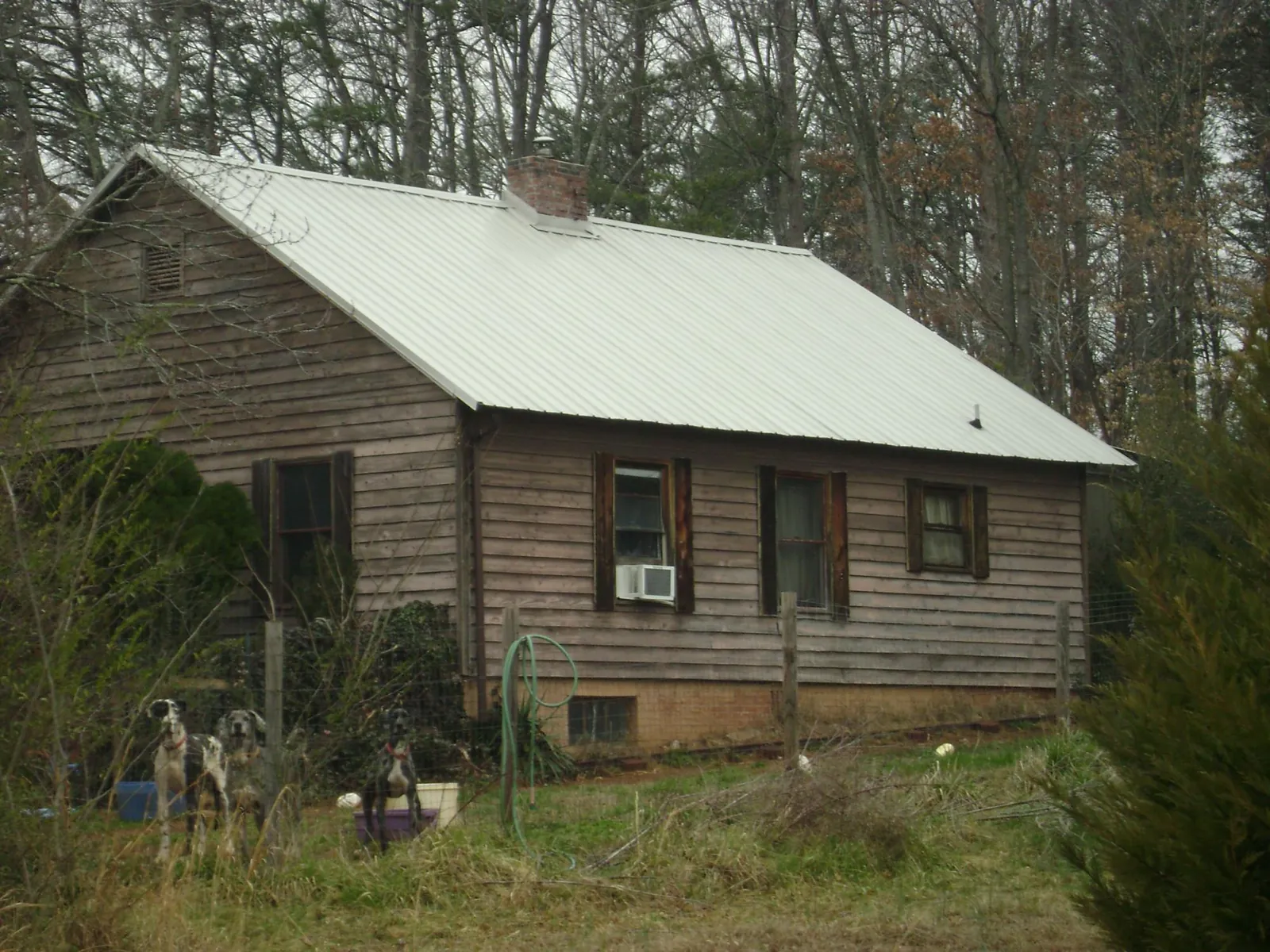 White metal roof on an old wood sided farmhouse, from a Metal Roof Installation job in Crossnore